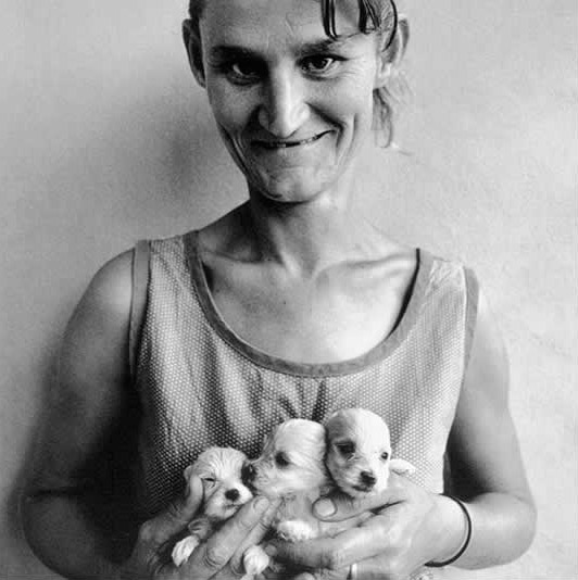 Wife of abattoir worker holding three puppies Orange Free State 1994 silver gelatin print 40 x 40 cm ed. 35