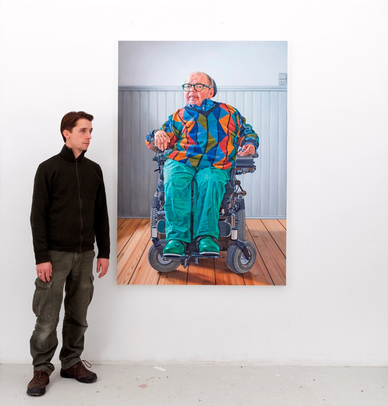 Allan Otte in front of the painted portrait of Evald Krog