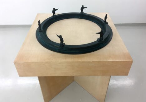 Øivind Nygård: Boy on circle shooting boy on square, 2001, Dark patinated bronze and birch veneer, 132 x 128 x 128 cm